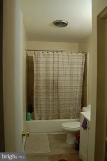 a bathroom with a toilet and shower