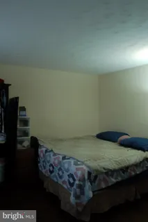 a bedroom with a bed and a book shelf