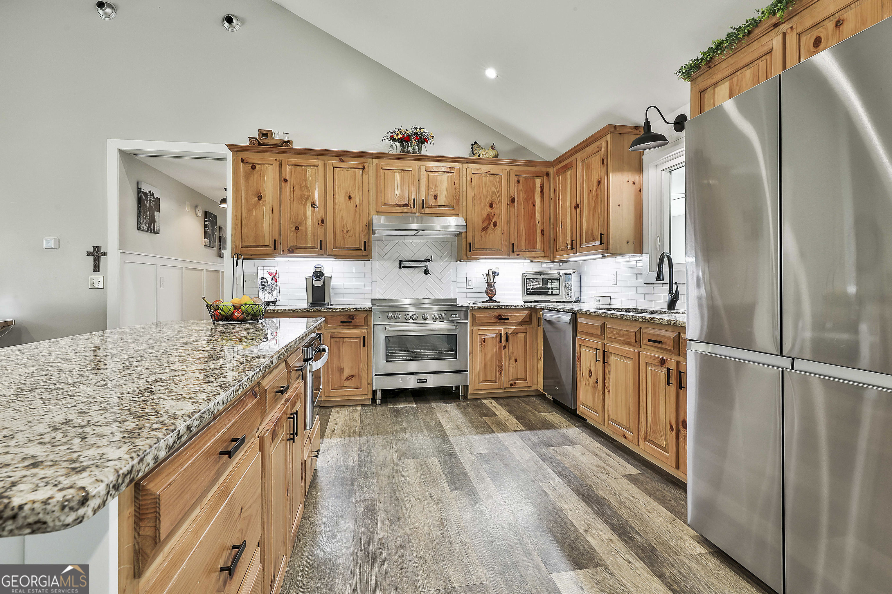 465 Little Road Sharpsburg, GA 30277 - Photo 13 of 67 a kitchen with stainless steel appliances granite countertop lots of counter top space and wooden floor