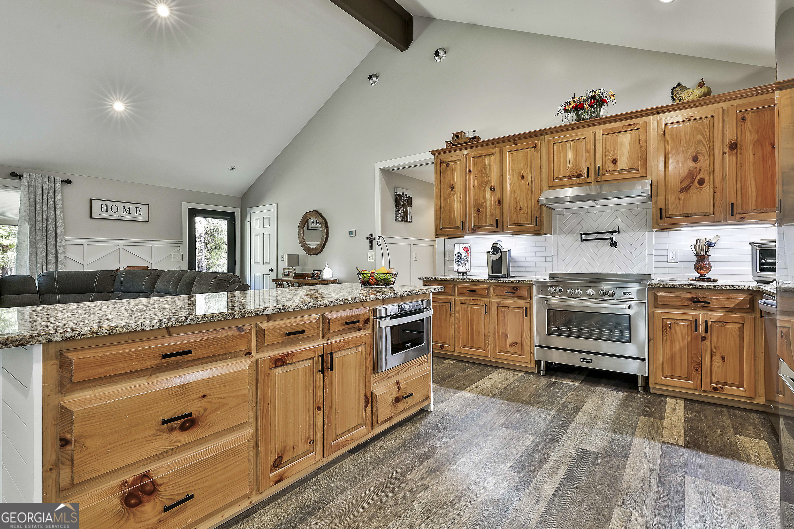 465 Little Road Sharpsburg, GA 30277 - Photo 14 of 67 a kitchen with stainless steel appliances granite countertop a stove and white cabinets