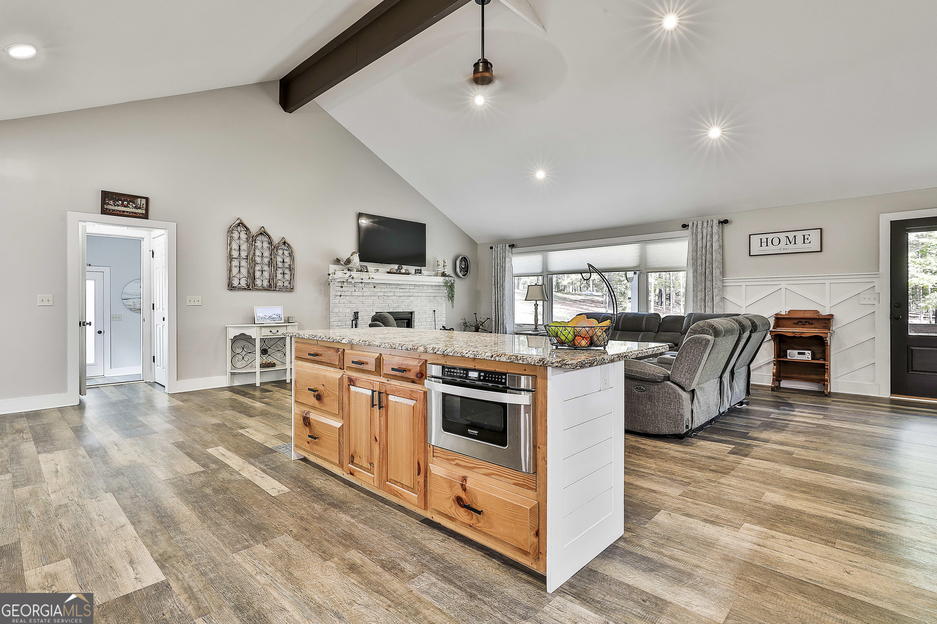 465 Little Road Sharpsburg, GA 30277 - Photo 15 of 67 a kitchen with kitchen island a stove top oven a sink a dining table and chairs