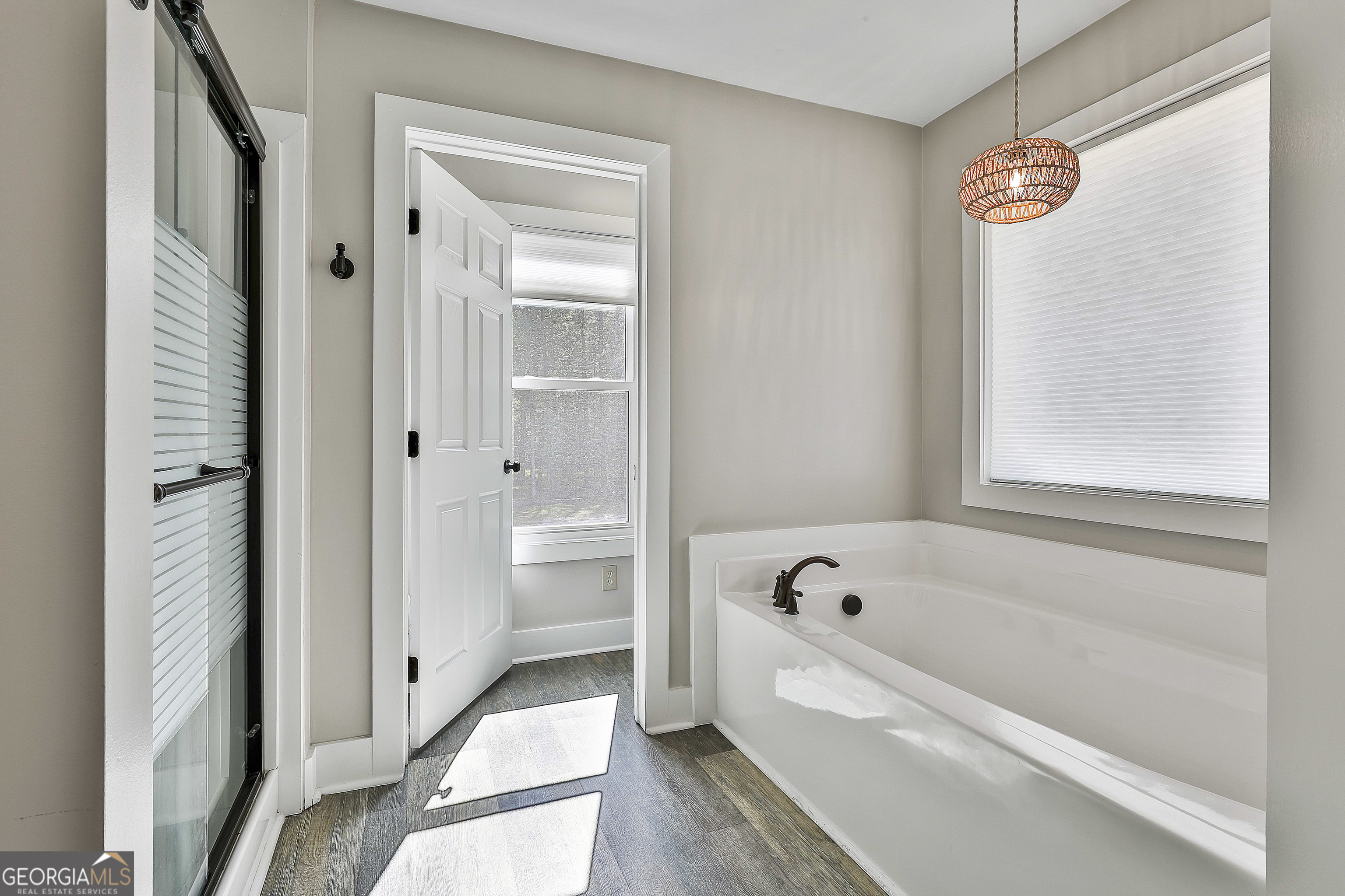 465 Little Road Sharpsburg, GA 30277 - Photo 30 of 67 a bathroom with a bathtub a mirror and a shower