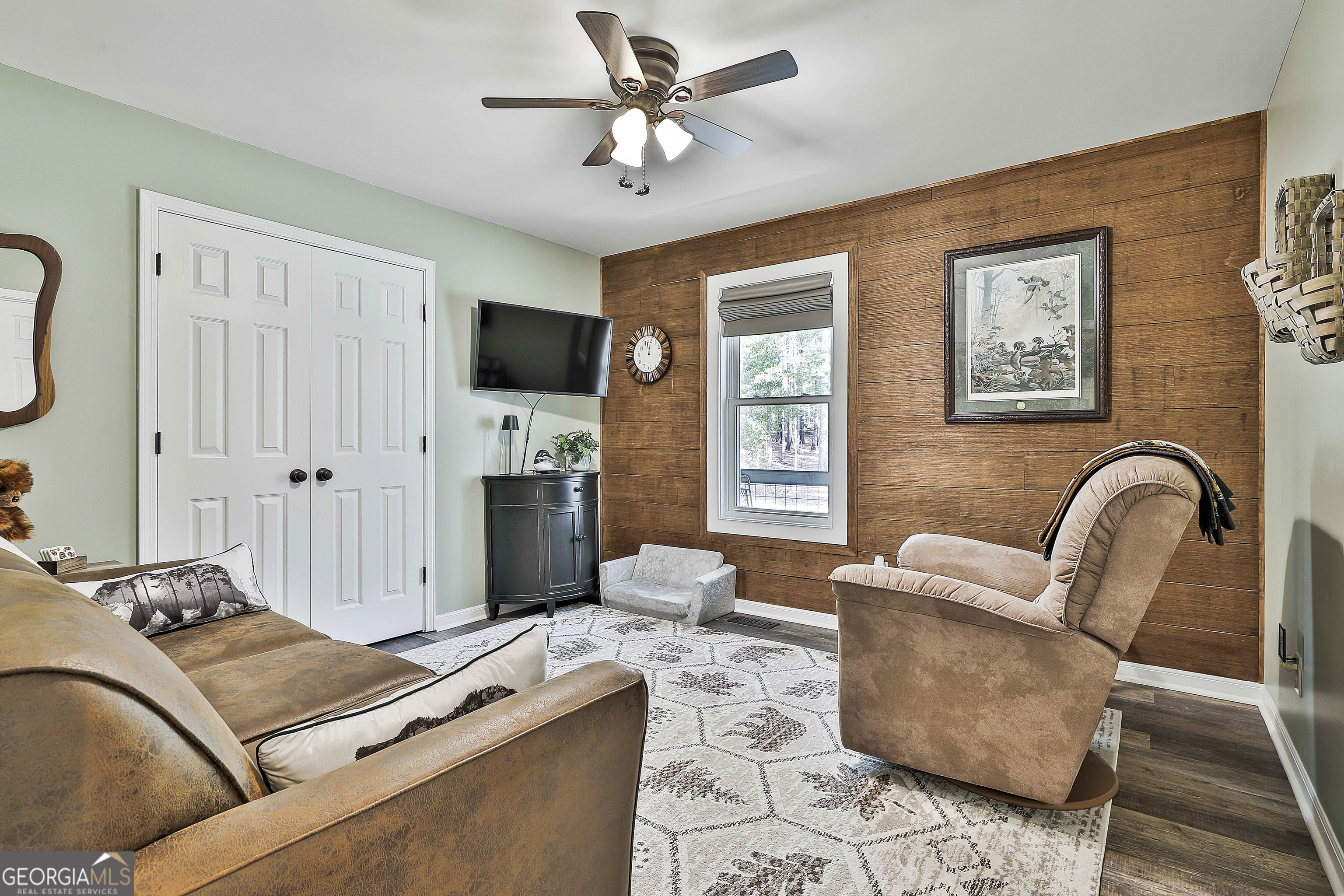 465 Little Road Sharpsburg, GA 30277 - Photo 32 of 67 a living room with furniture ceiling fan and a flat screen tv
