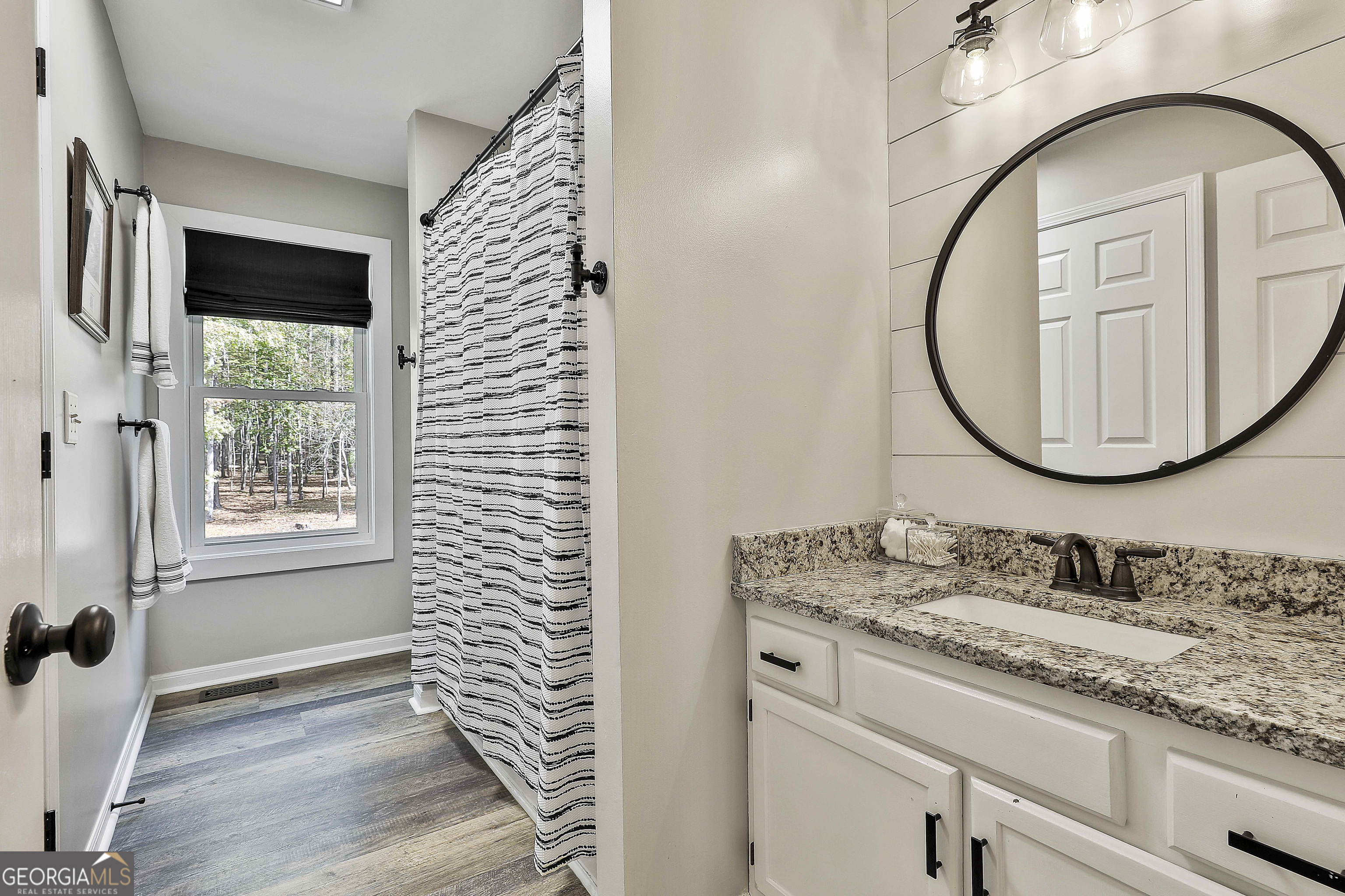 465 Little Road Sharpsburg, GA 30277 - Photo 33 of 67 a bathroom with a sink and a mirror