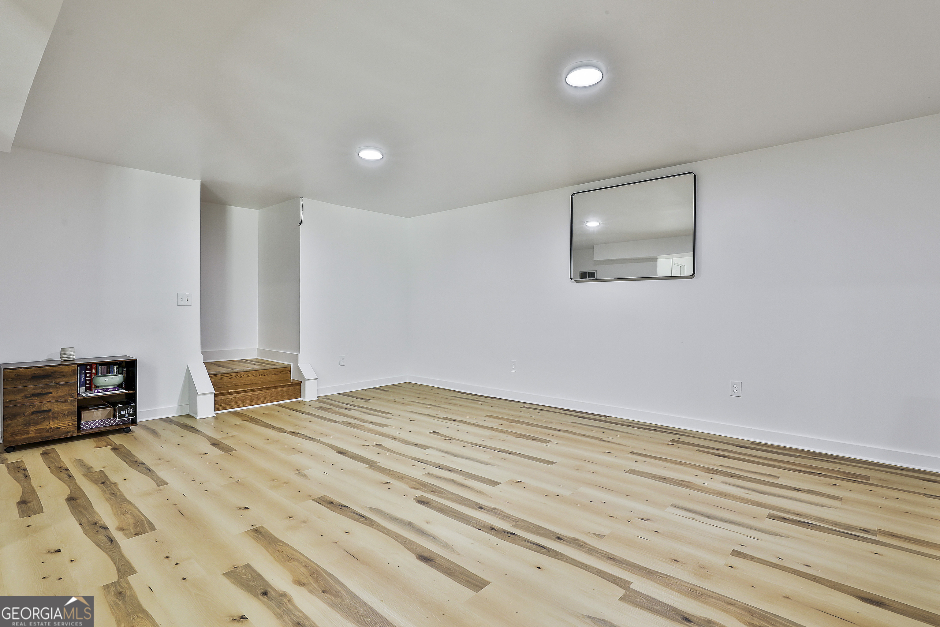 465 Little Road Sharpsburg, GA 30277 - Photo 37 of 67 a bedroom with a large bed and a wooden floor