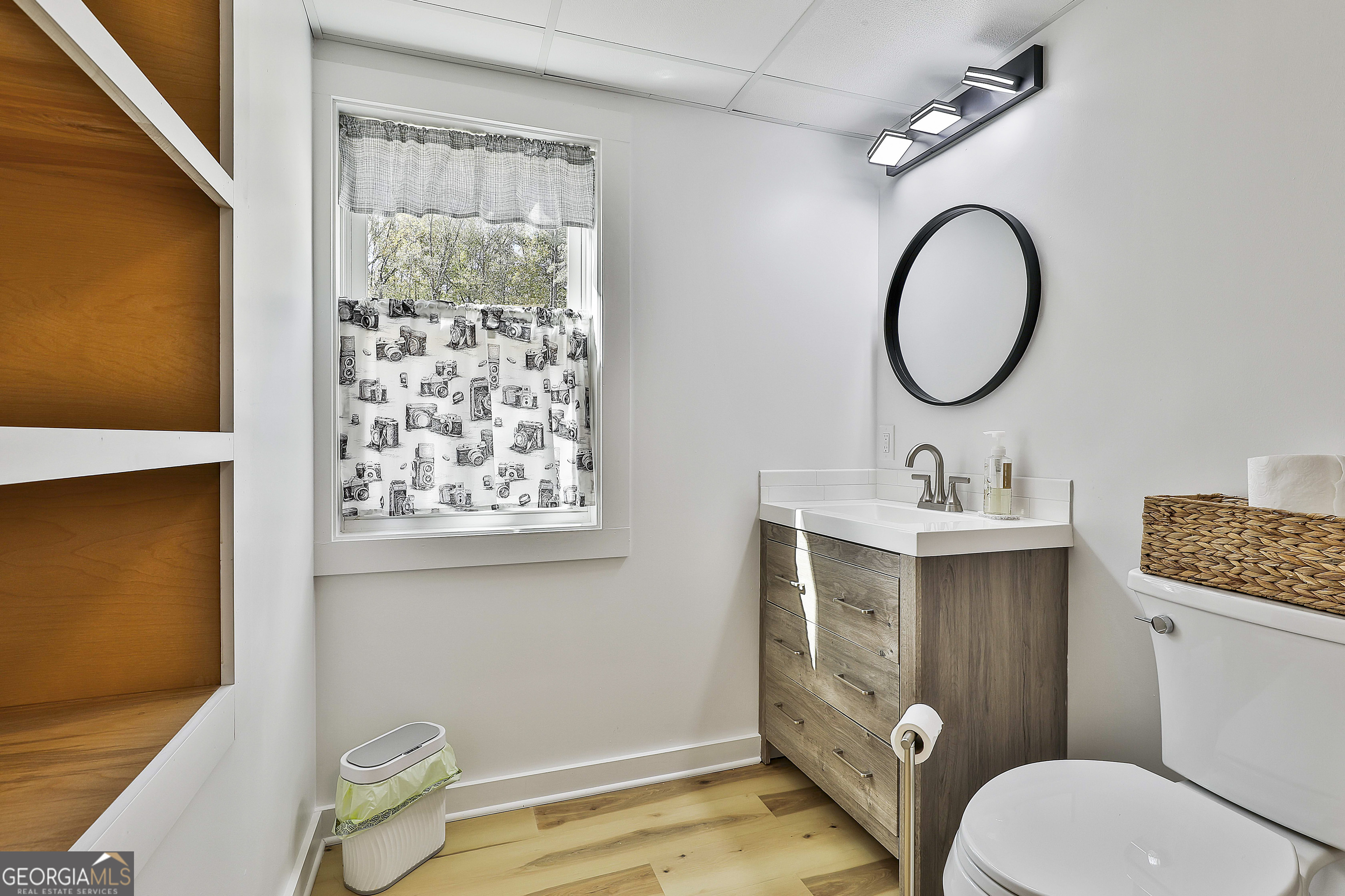 465 Little Road Sharpsburg, GA 30277 - Photo 44 of 67 a bathroom with a granite countertop toilet sink and mirror