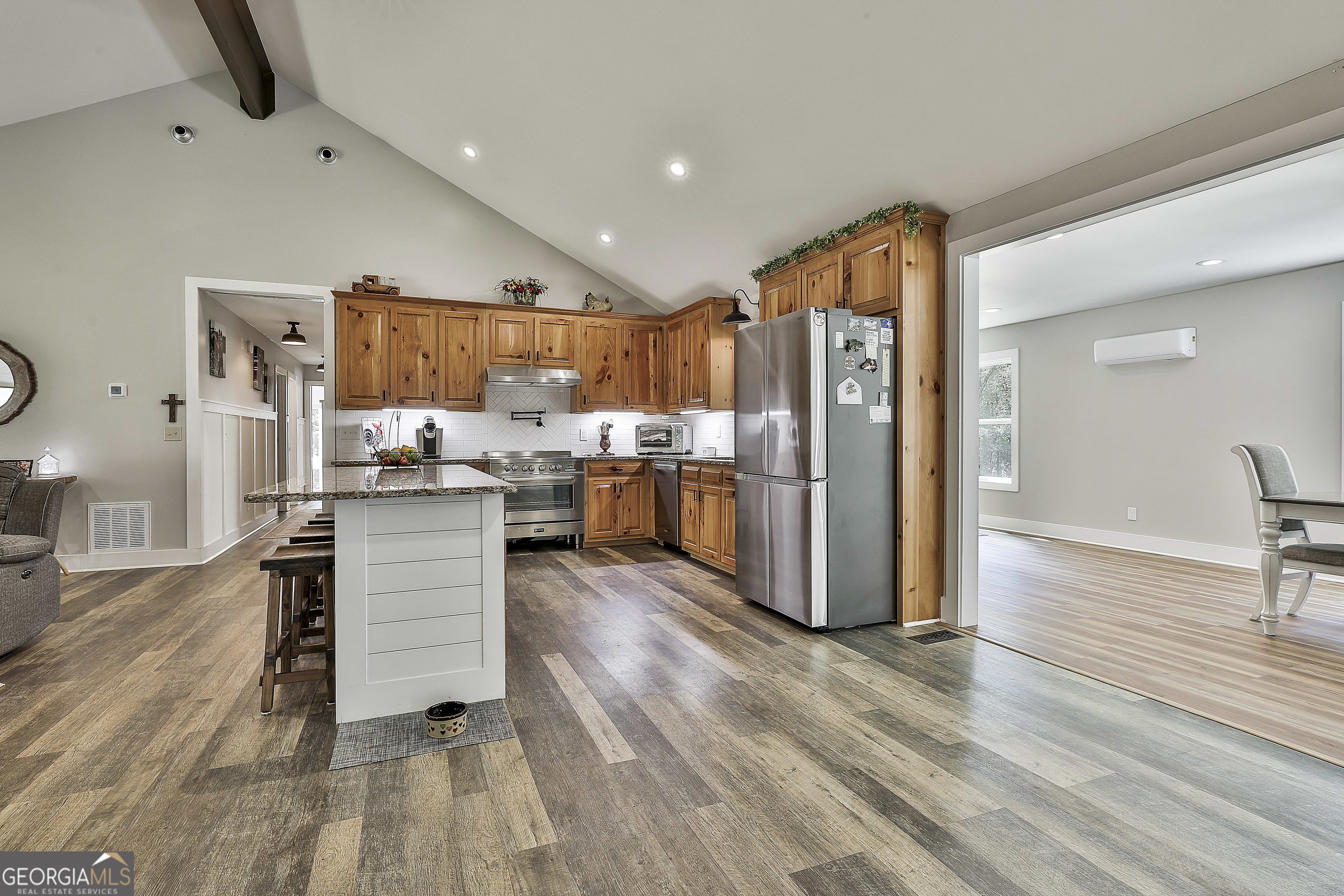 465 Little Road Sharpsburg, GA 30277 - Photo 6 of 67 a kitchen with stainless steel appliances kitchen island granite countertop a refrigerator and a stove top oven