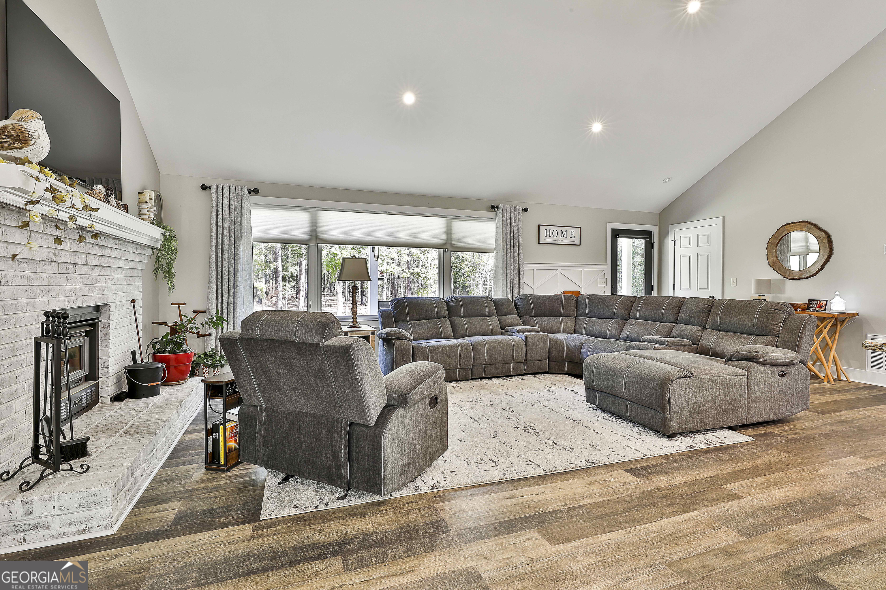 465 Little Road Sharpsburg, GA 30277 - Photo 9 of 67 a living room with furniture a fireplace and a flat screen tv