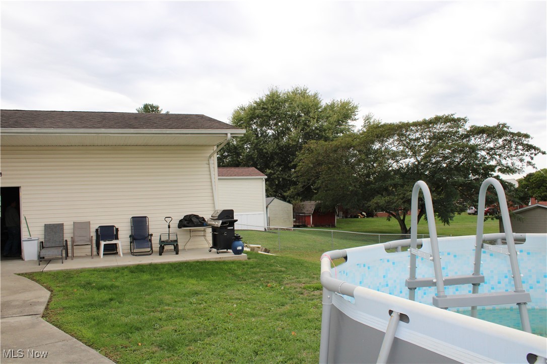 56 3rd Street Rayland, OH 43943 - Photo 15 of 46 View of green lawn with a patio and an outdoor pool