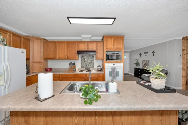 a kitchen with stainless steel appliances granite countertop a refrigerator and a sink