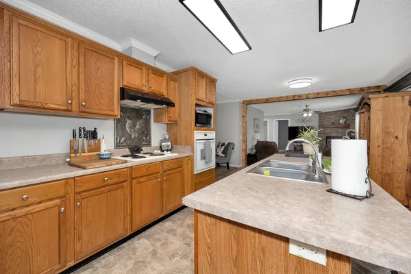 a kitchen with sink refrigerator and cabinets