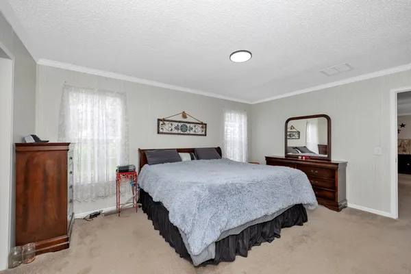 a bedroom with a bed and window