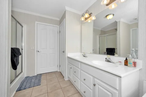 a bathroom with a double vanity sink and a mirror
