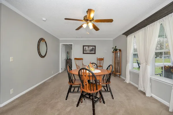 a view of a dining room with furniture and window