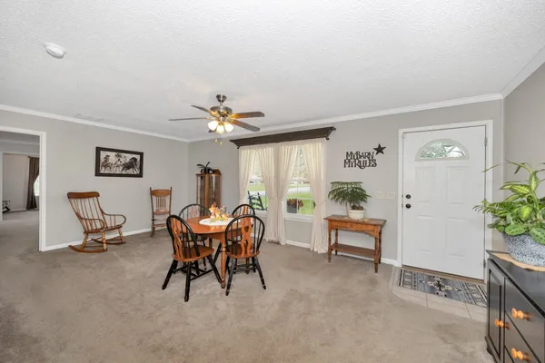 a view of a dining room with furniture and chandelier