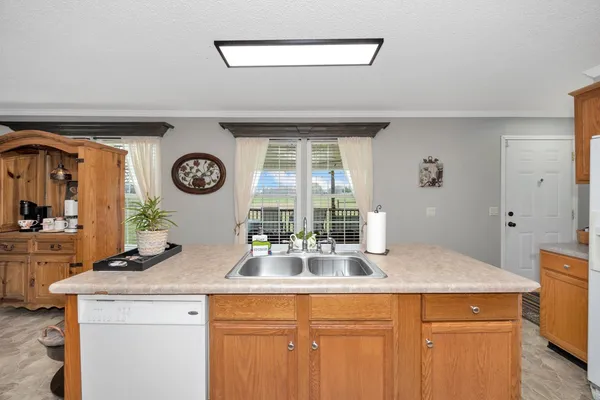a kitchen with a sink and a clock on the wall