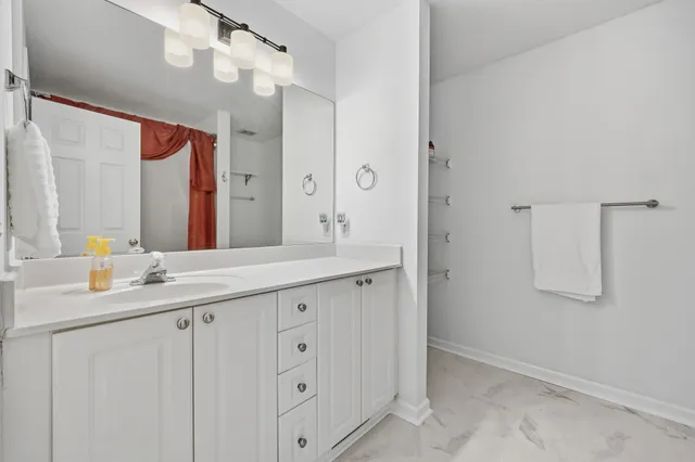 a bathroom with a granite countertop sink mirror and a