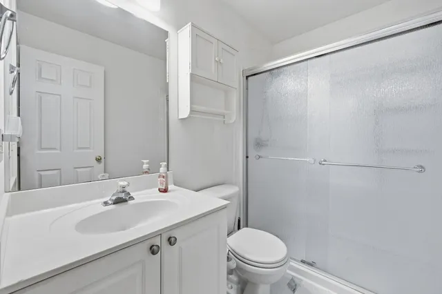a bathroom with a sink toilet and shower