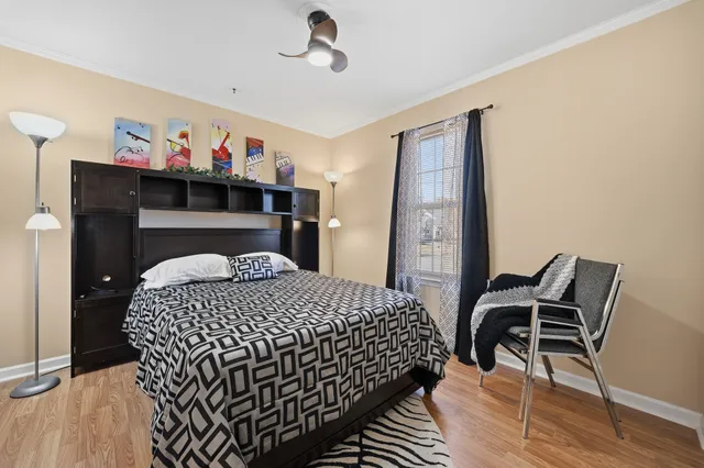 a bedroom with a bed and wooden floor