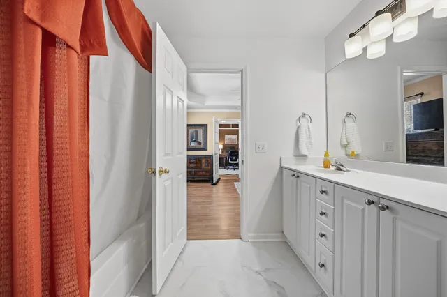 a bathroom with a sink a mirror and a shower