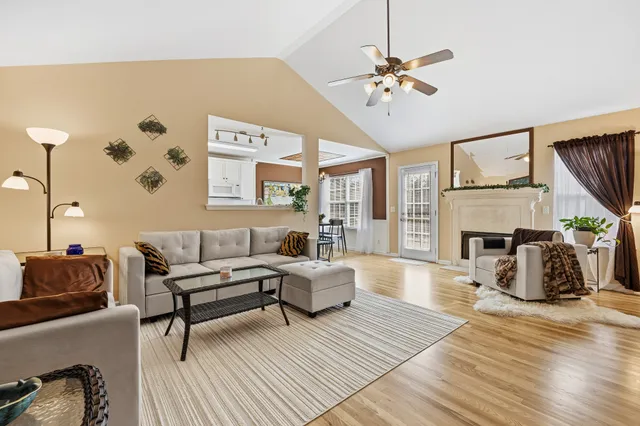 a living room with furniture a fireplace and a flat screen tv