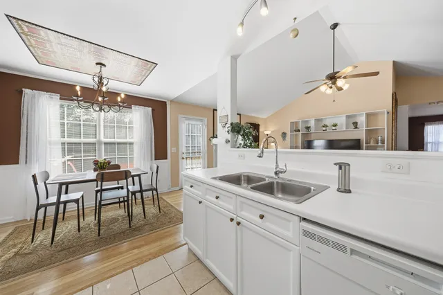 a kitchen with center island table and chairs