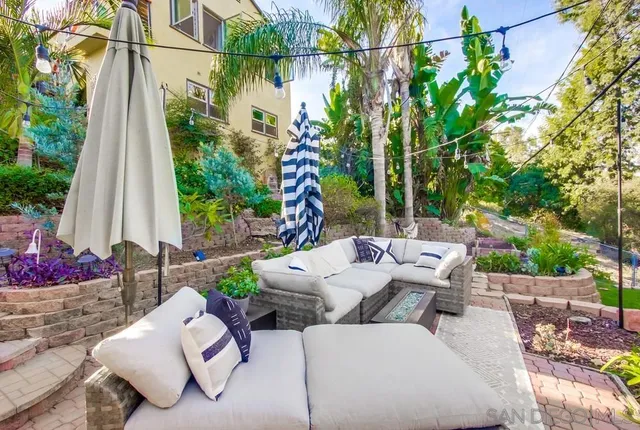 a view of backyard with outdoor seating and flowers