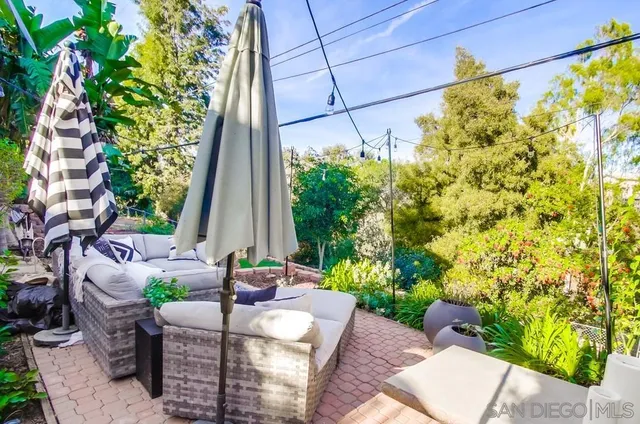 a view of a patio with table and chairs and potted plants