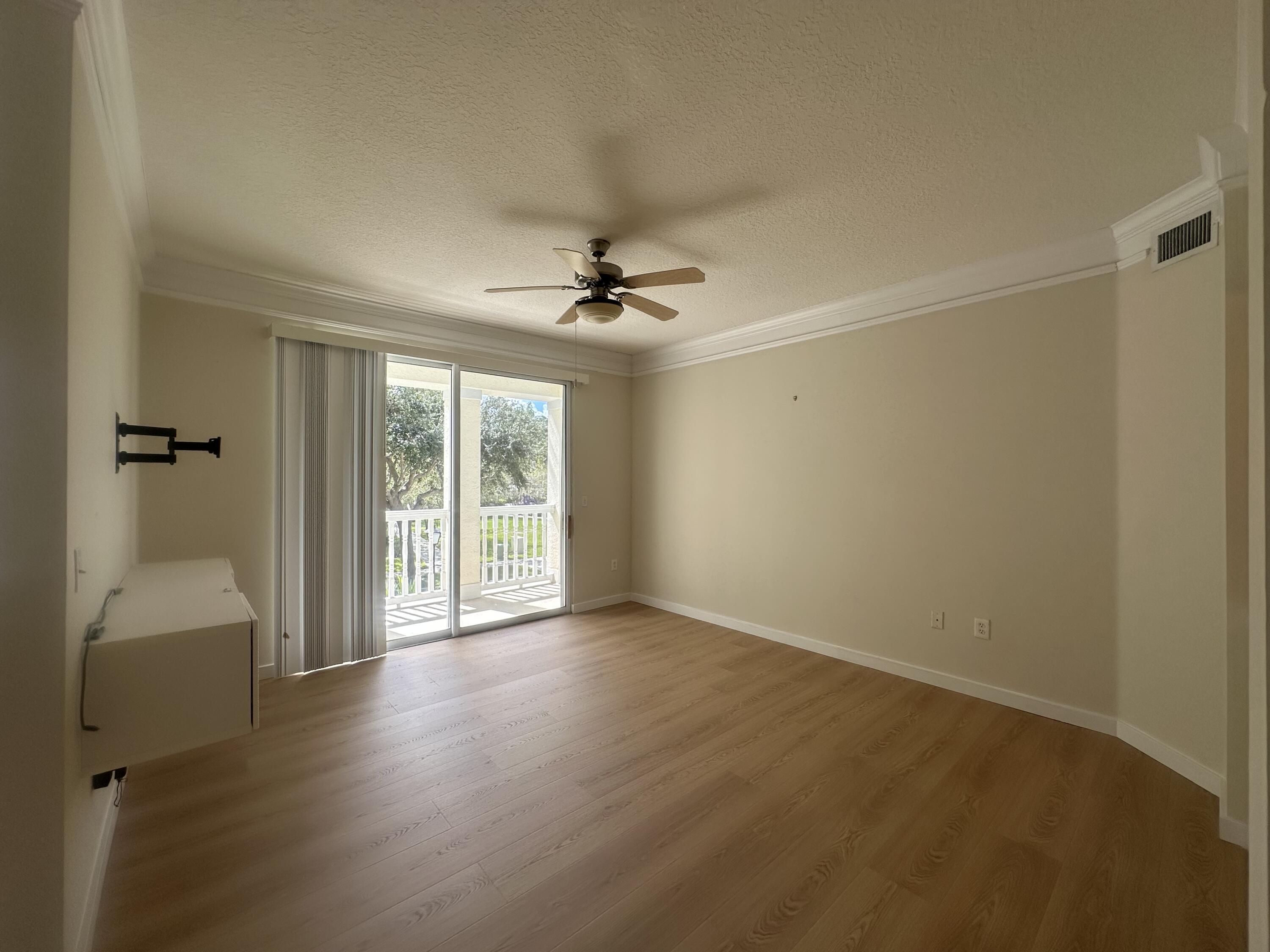 225 Murcia Drive, Unit 208 Jupiter, FL 33458 - Photo 11 of 32 a view of a livingroom with a ceiling fan and hardwood floor
