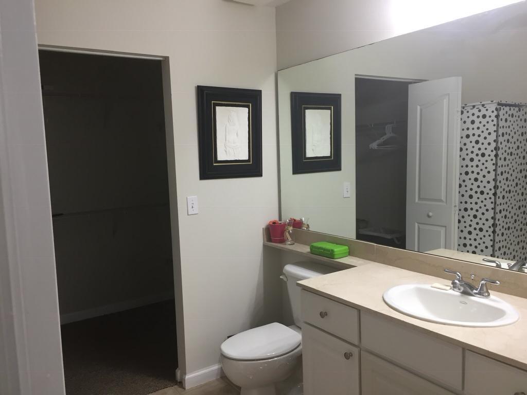 225 Murcia Drive, Unit 208 Jupiter, FL 33458 - Photo 20 of 32 a bathroom with a sink vanity mirror and toilet
