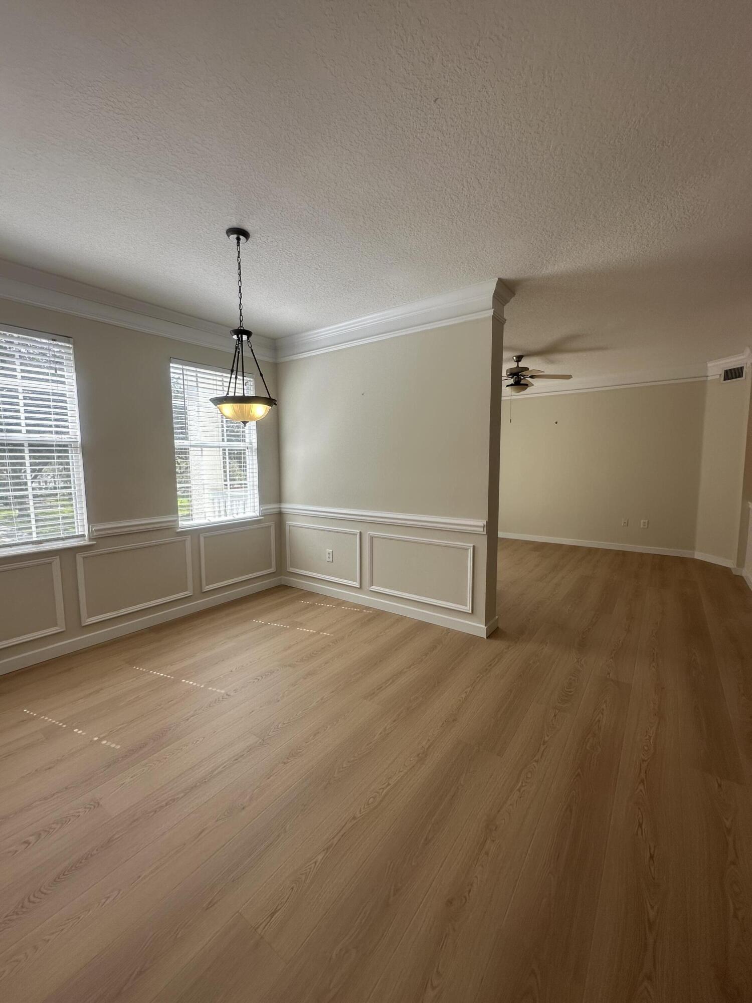 225 Murcia Drive, Unit 208 Jupiter, FL 33458 - Photo 4 of 32 an empty room with windows and pillars in it
