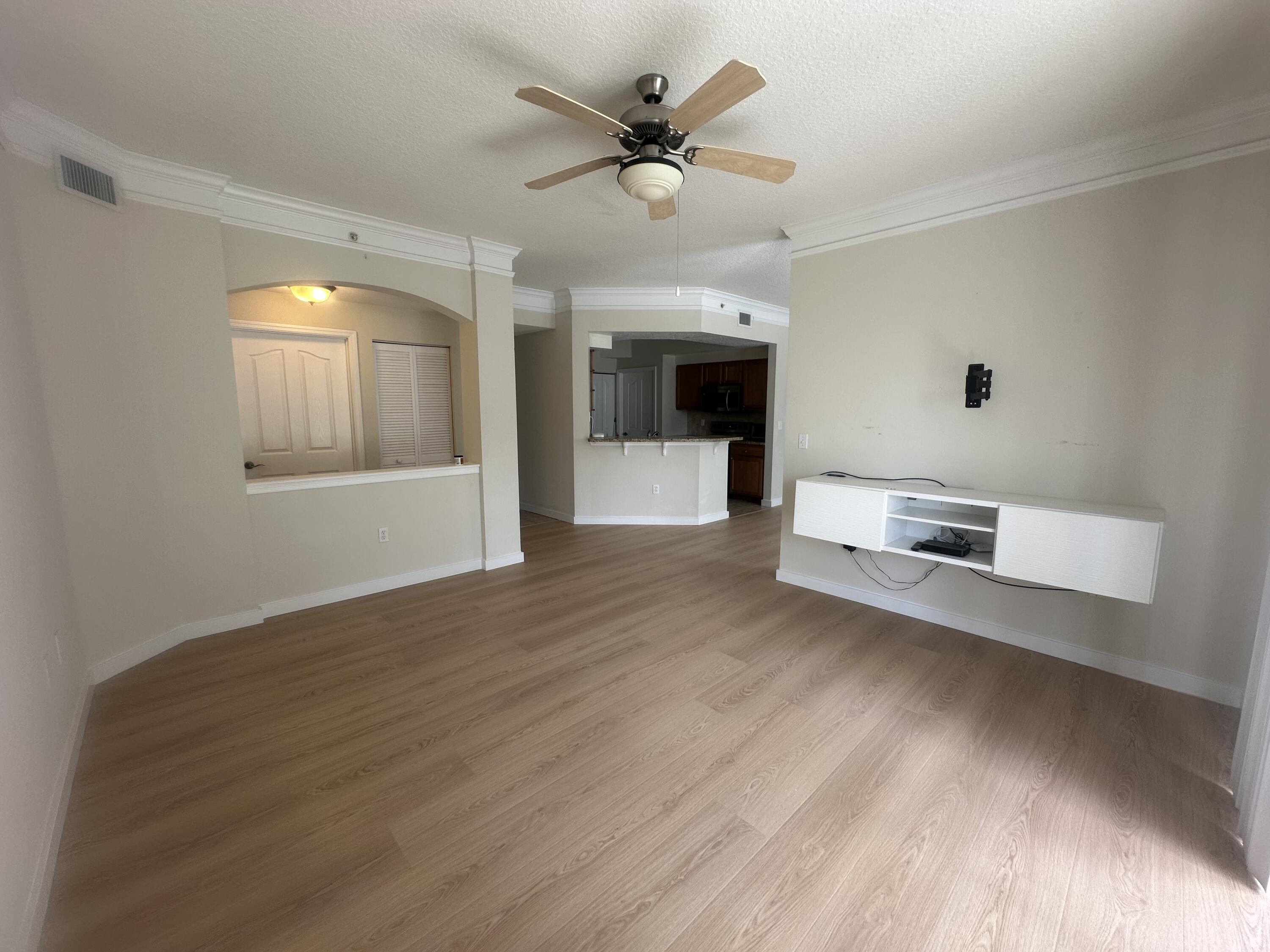 225 Murcia Drive, Unit 208 Jupiter, FL 33458 - Photo 10 of 32 a view of a livingroom with a ceiling fan and wooden floor