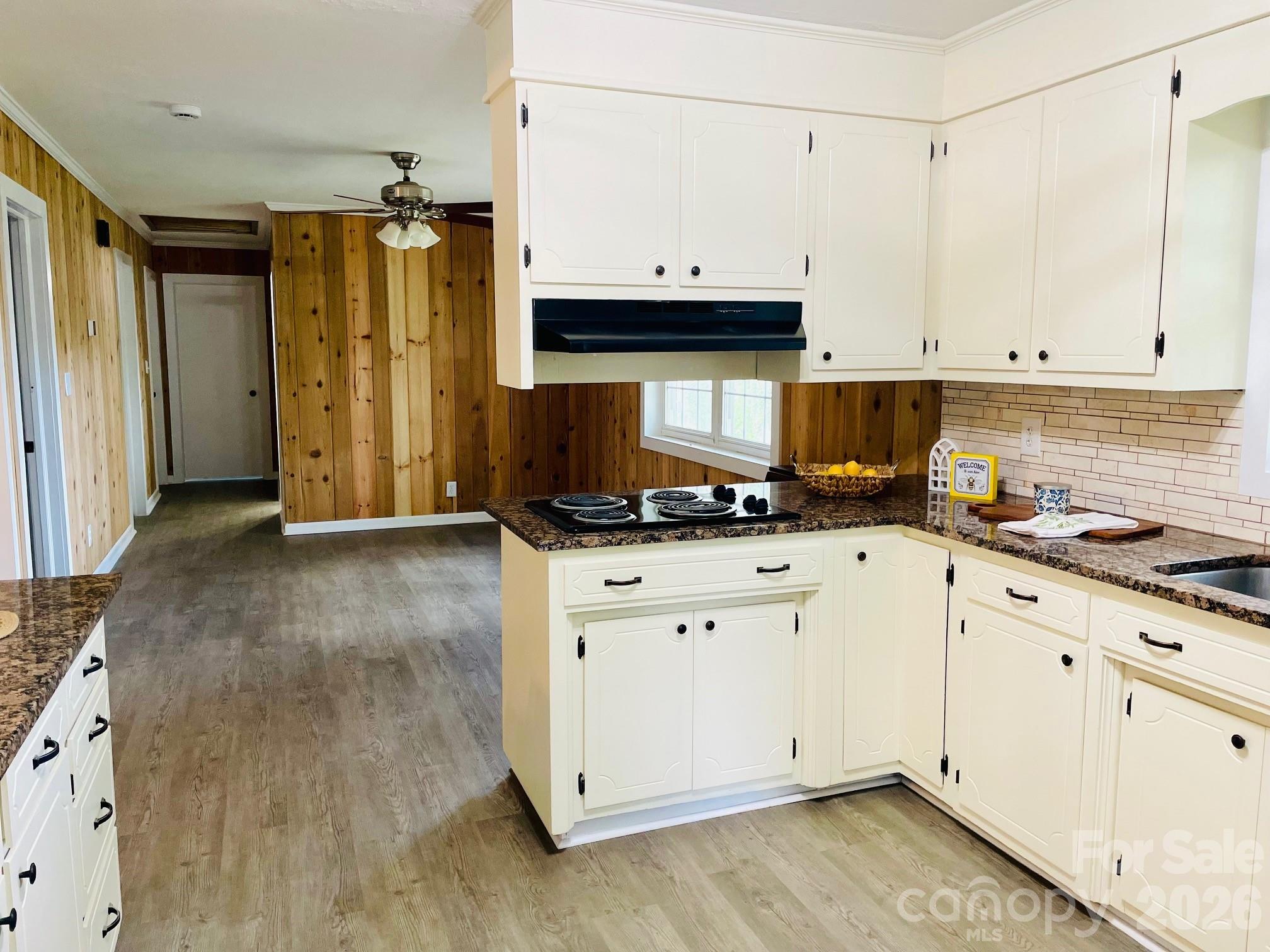 511 Sunbeam Farm Road Cherryville, NC 28021 - Photo 11 of 29 a view of kitchen with granite countertop white cabinets stainless steel appliances and wooden floor
