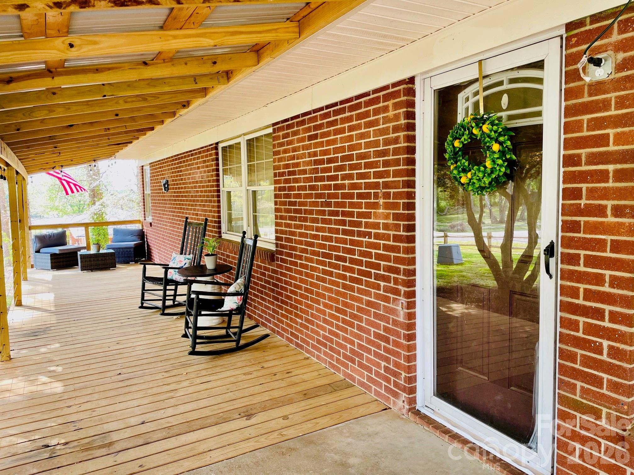 511 Sunbeam Farm Road Cherryville, NC 28021 - Photo 3 of 29 a view of a patio with table and chairs and potted plants