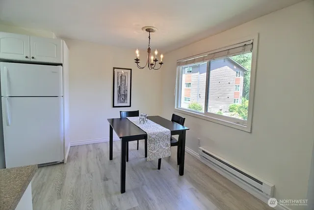a view of a dining room with furniture window and wooden floor