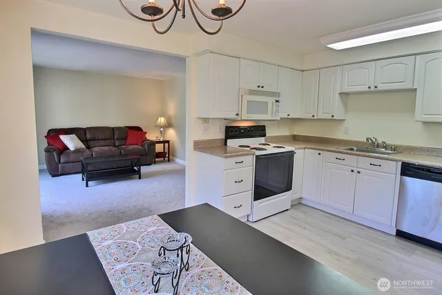 a kitchen with a sink cabinets and wooden floor
