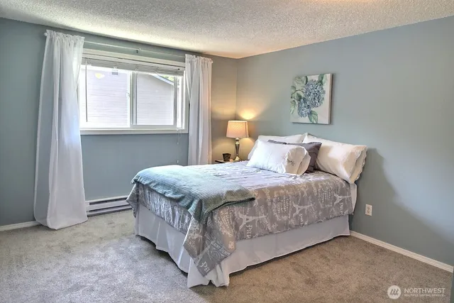 a bedroom with a bed and window