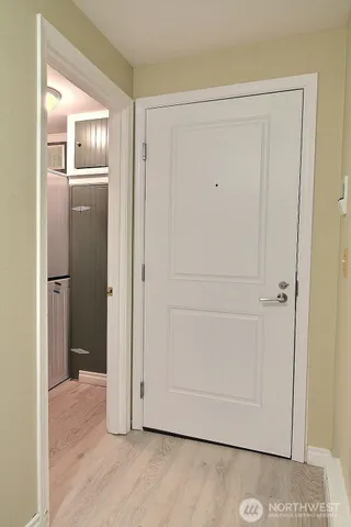 a view of empty room with window and refrigerator