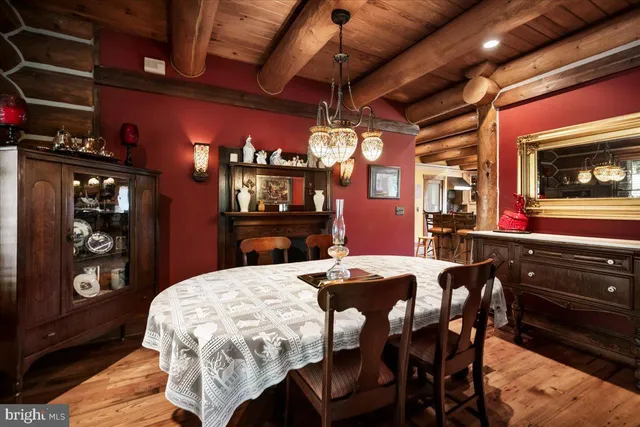 a dining room with a wooden table and chairs
