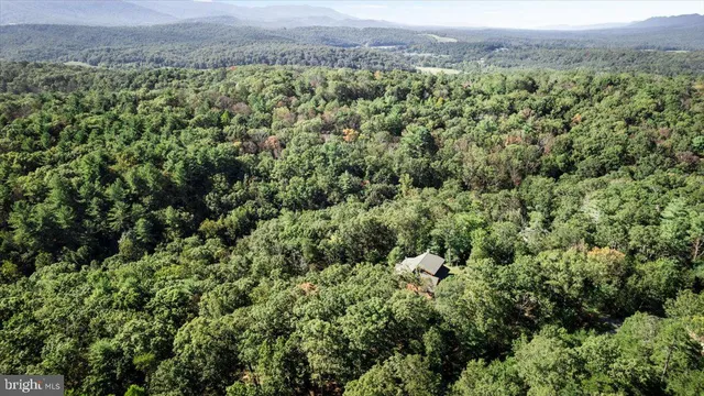 a view of a house with a yard and floor to ceiling window