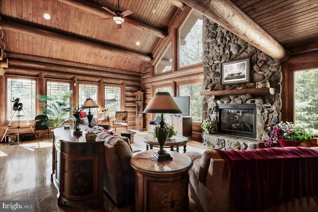 a living room with fireplace furniture and a large window