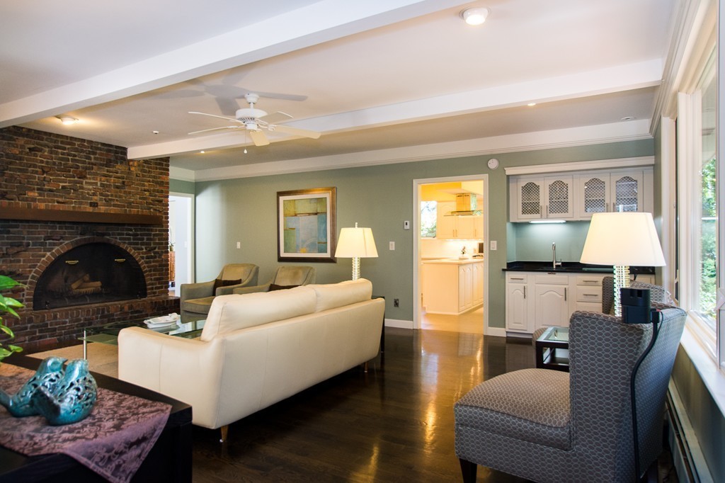 46 Algonquin Road Canton, MA 02021 - Photo 14 of 30 a living room with furniture a fireplace and a flat screen tv