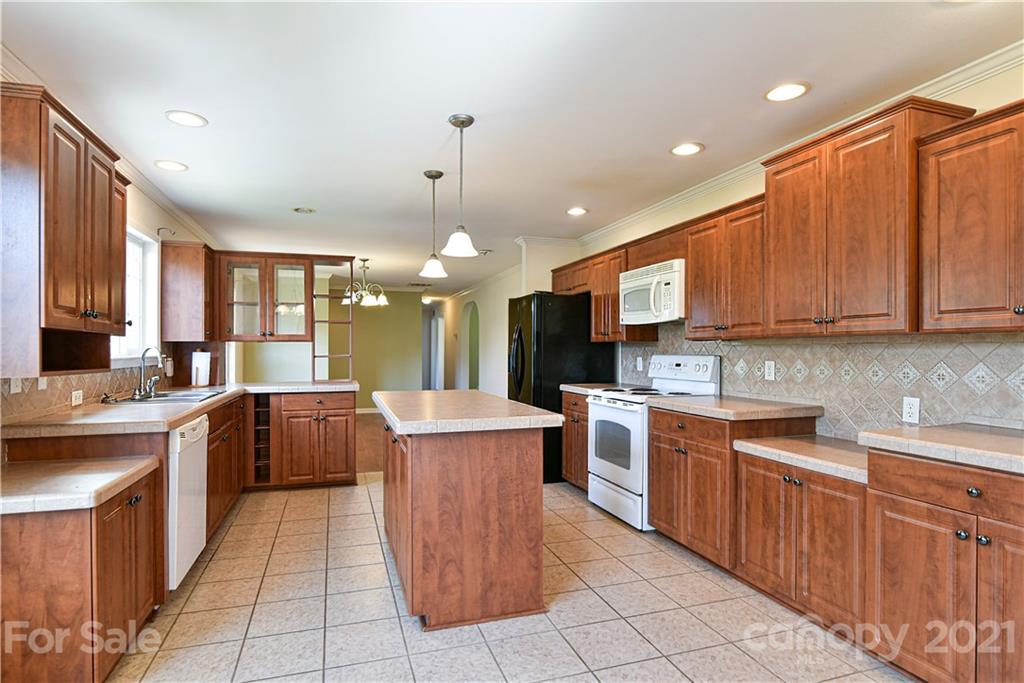 699 Pleasant Hill Road Clyde, NC 28721 - Photo 11 of 32 a kitchen with a sink stove and cabinets