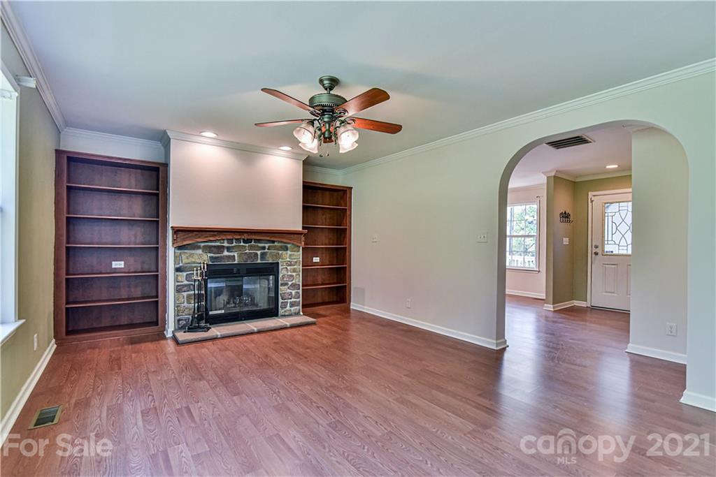 699 Pleasant Hill Road Clyde, NC 28721 - Photo 17 of 32 wooden floor fireplace and natural light in room