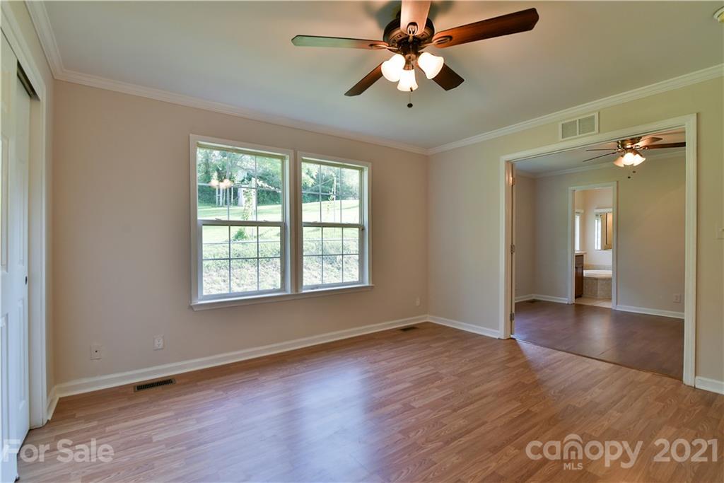 699 Pleasant Hill Road Clyde, NC 28721 - Photo 20 of 32 wooden floor in an empty room with a window