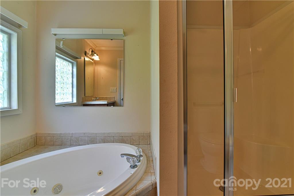 699 Pleasant Hill Road Clyde, NC 28721 - Photo 22 of 32 a bathroom with a bathtub
