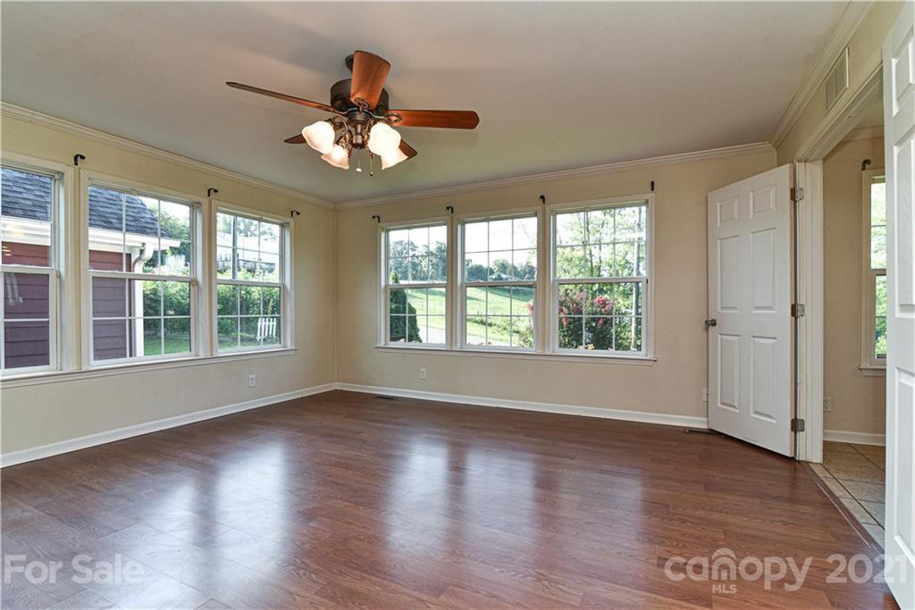 699 Pleasant Hill Road Clyde, NC 28721 - Photo 23 of 32 a view of an empty room with wooden floor and a window