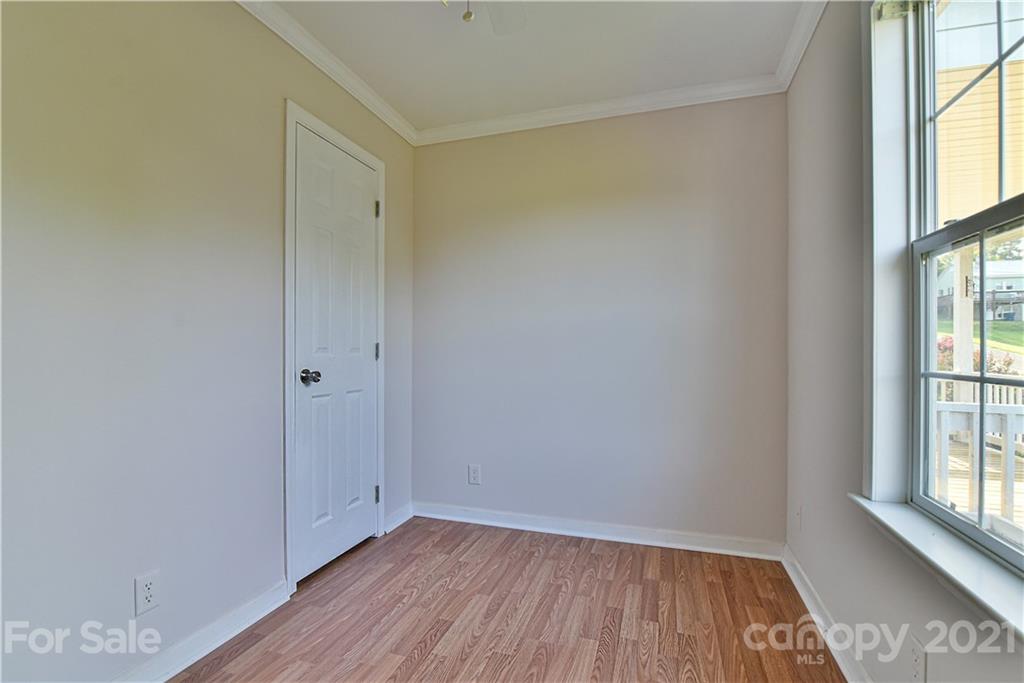 699 Pleasant Hill Road Clyde, NC 28721 - Photo 24 of 32 a view of an empty room with wooden floor and a window