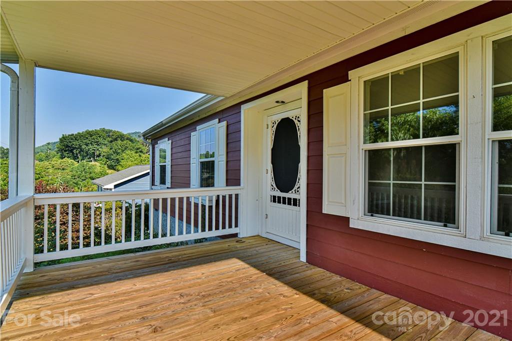 699 Pleasant Hill Road Clyde, NC 28721 - Photo 5 of 32 a view of a deck with wooden floor and fence