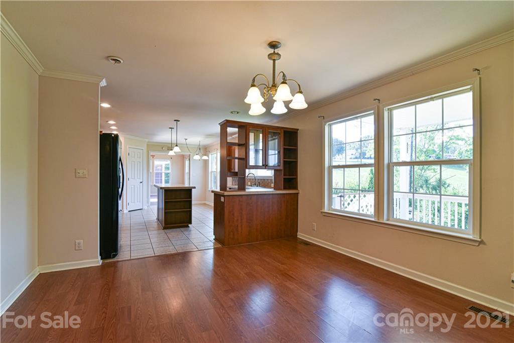 699 Pleasant Hill Road Clyde, NC 28721 - Photo 6 of 32 a view of an empty room with wooden floor and a window